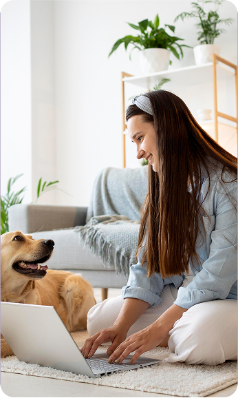 image of a woman sitting on the floor with her dog and a laptop