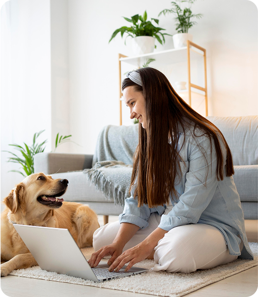 image of a woman sitting on the floor with her dog and a laptop